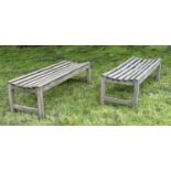 GARDEN BENCHES, a pair, well weathered teak and slatted, 140cm W x 50cm D x 44cm H. (2)