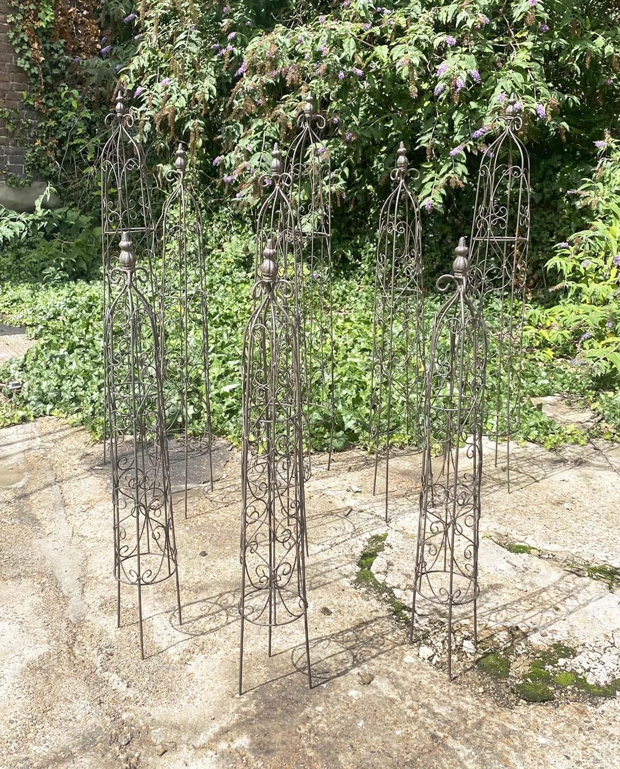 ARCHITECTURAL GARDEN OBELISKS, a set of nine, in metal, graduated sizes. (9)