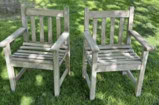 GARDEN ARMCHAIRS, a pair, silvery weathered teak and slatted with flat top arms, 86cm H x 50cm W x