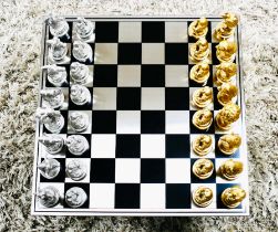 CHESS SET, with gilt and silvered animal pieces, board 60cm x 60cm.