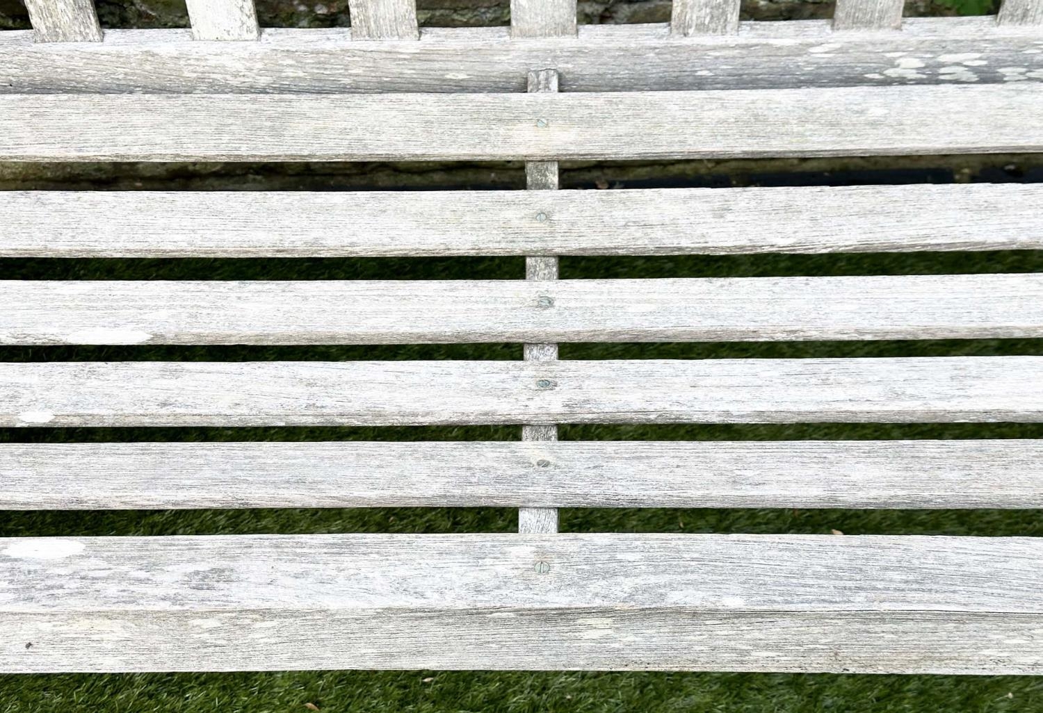 GARDEN BENCH, silvery weathered teak of slatted construction, 130cm W, by 'Lister'. - Image 4 of 8