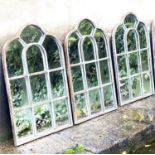 ARCHITECTURAL GARDEN MIRRORS, a set of three, with metal frames, 60cm H x 39cm. (3)