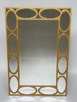 WALL MIRROR, rectangular gilt with oval panelled marginal plates and bevelled mirror throughout,