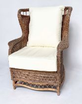 CONSERVATORY ARMCHAIR, mid 20th century rattan framed and cane woven with shaped back and