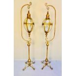 LANTERNS ON STANDS, a pair, regency style, gilt metal, 163cm H x 35cm x 33cm. (2)