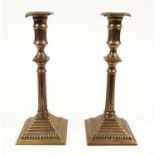 A PAIR OF GEORGE III BRASS CANDLESTICKS, in the Adamesque style, each 26cm H.