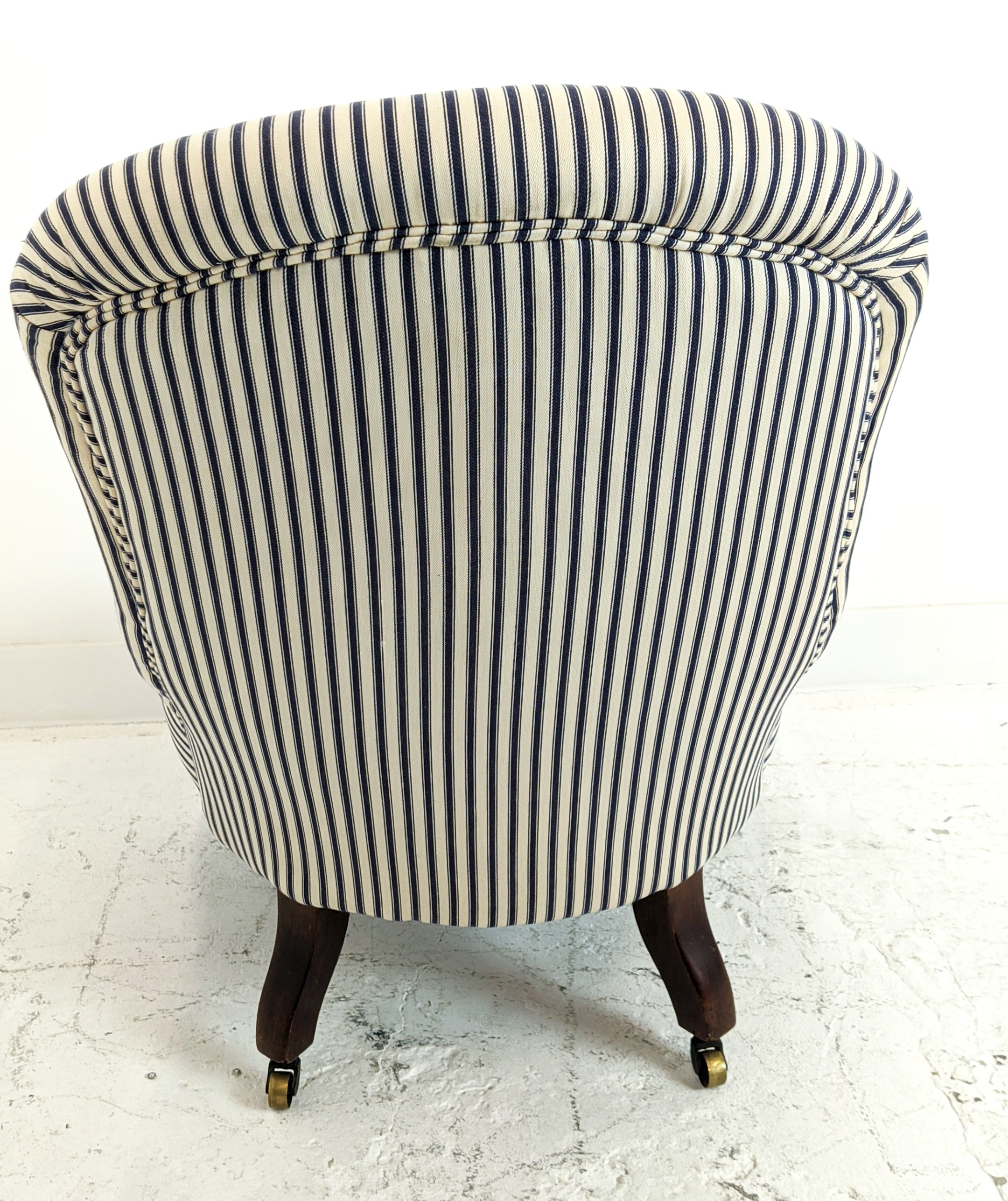 SLIPPER CHAIR, Victorian mahogany in blue and white ticking, 82cm H x 78cm x 62cm. (front castors - Image 6 of 6