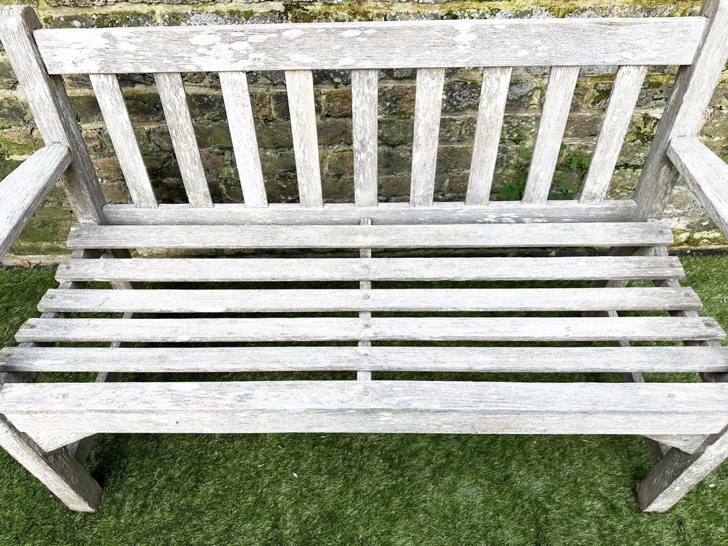 GARDEN BENCH, silvery weathered teak of slatted construction, 130cm W, by 'Lister'. - Image 5 of 8