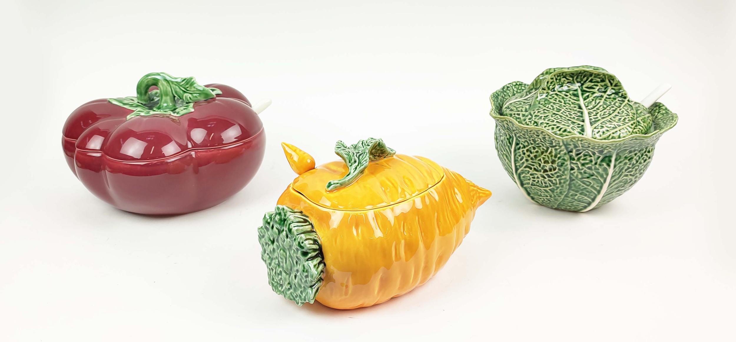 THREE LARGE CERAMIC TUREENS OF FRUIT AND VEGETABLE, in the form of tomato, cabbage and carrot, all