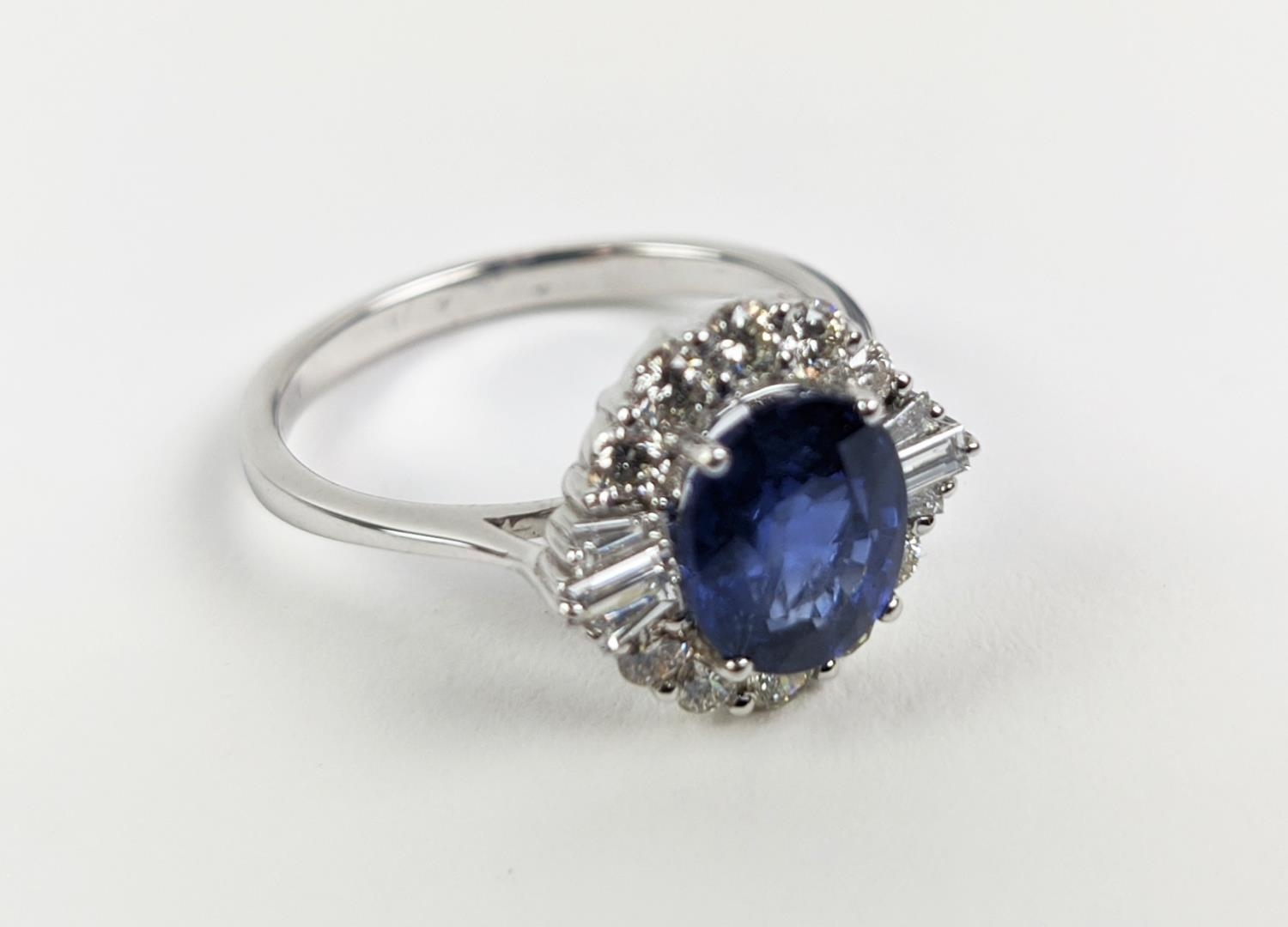 AN 18CT WHITE GOLD SAPPHIRE AND DIAMOND HALO RING, the central oval mixed cut sapphire of - Image 5 of 9