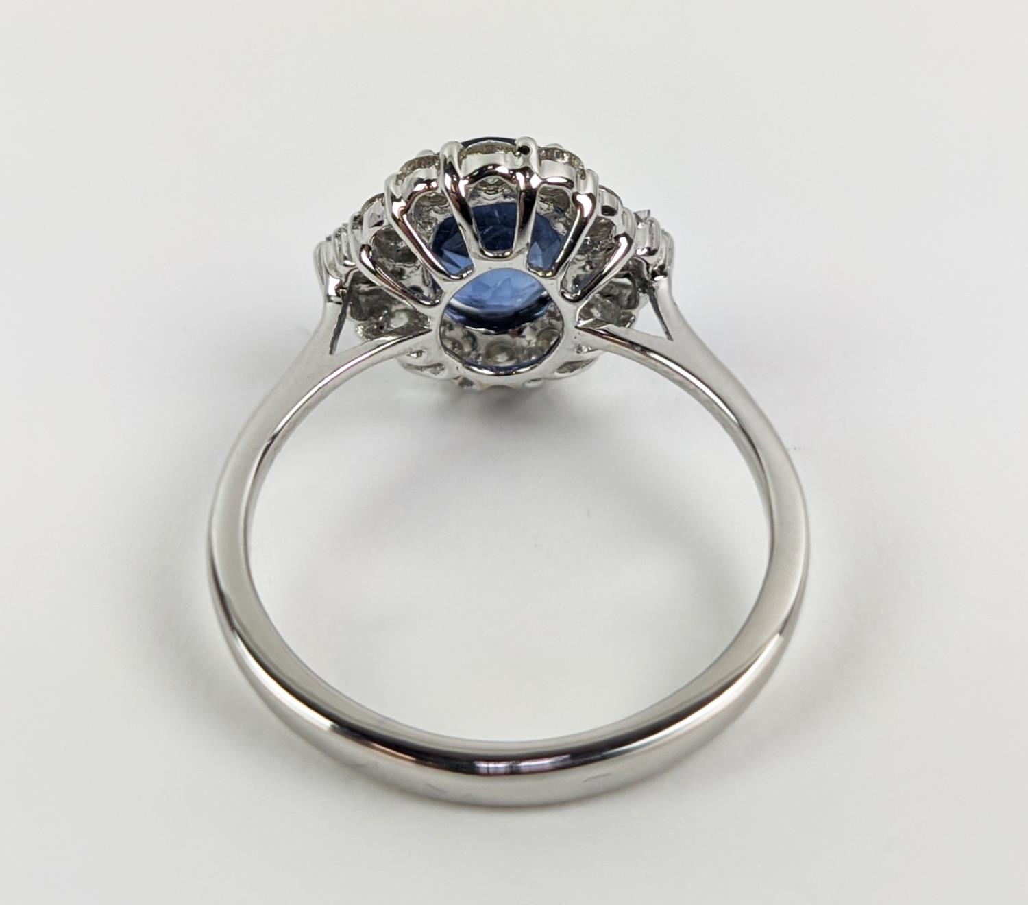 AN 18CT WHITE GOLD SAPPHIRE AND DIAMOND HALO RING, the central oval mixed cut sapphire of - Image 7 of 9