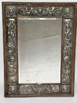 WALL MIRROR, late 19th century Continental oak rectangular bevelled mirror within repoussé