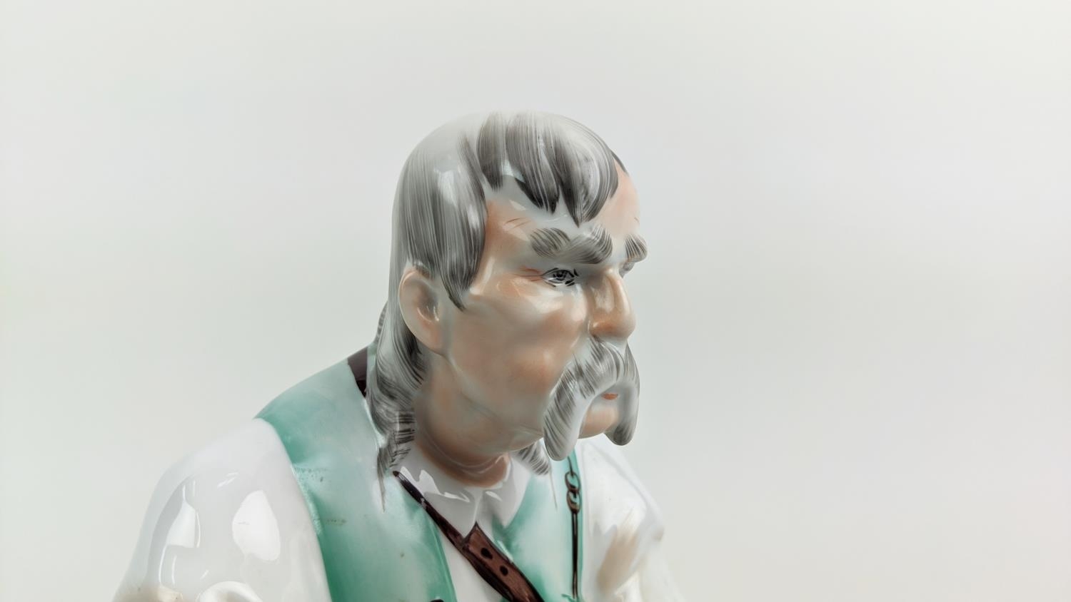 A ZSOLNAY FIGURE OF A MAN WITH A KNIFE, seated, made in Hungary, hand painted, 33cm high - Image 2 of 9