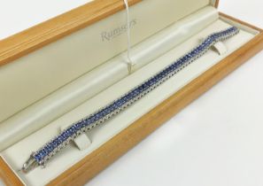AN 18CT WHITE GOLD TANZANITE AND DIAMOND BRACELET, set with sixty links, each link with a faceted