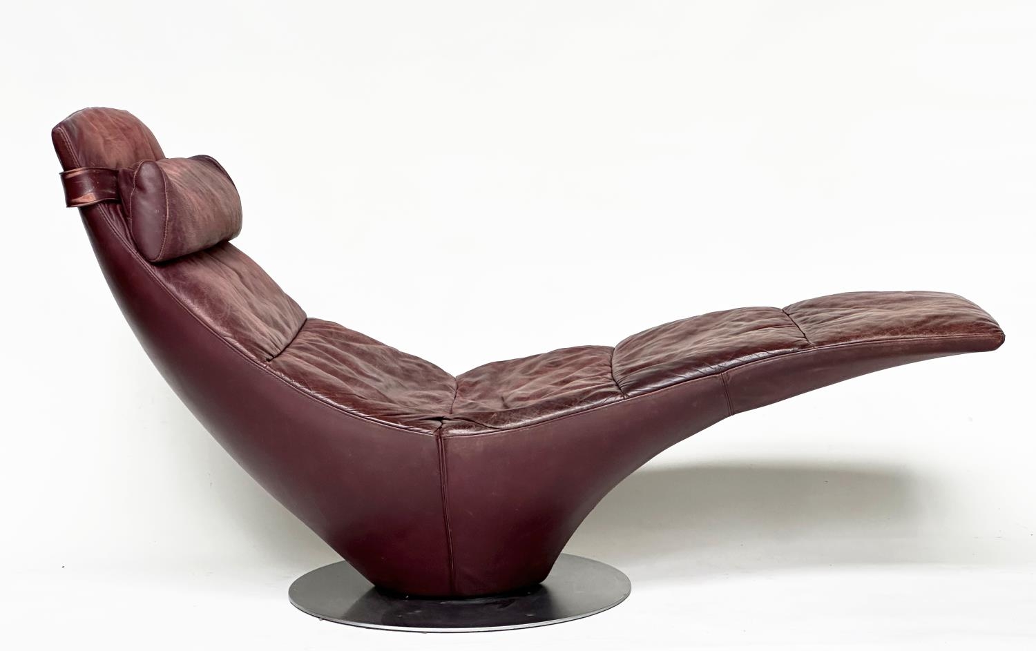 NATUZZI CHAISE, stitched leather revolving on circular steel support, 173cm W.