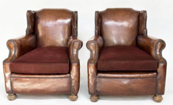 CLUB WING ARMCHAIRS, a pair, early 20th century English studded natural antique brown leather