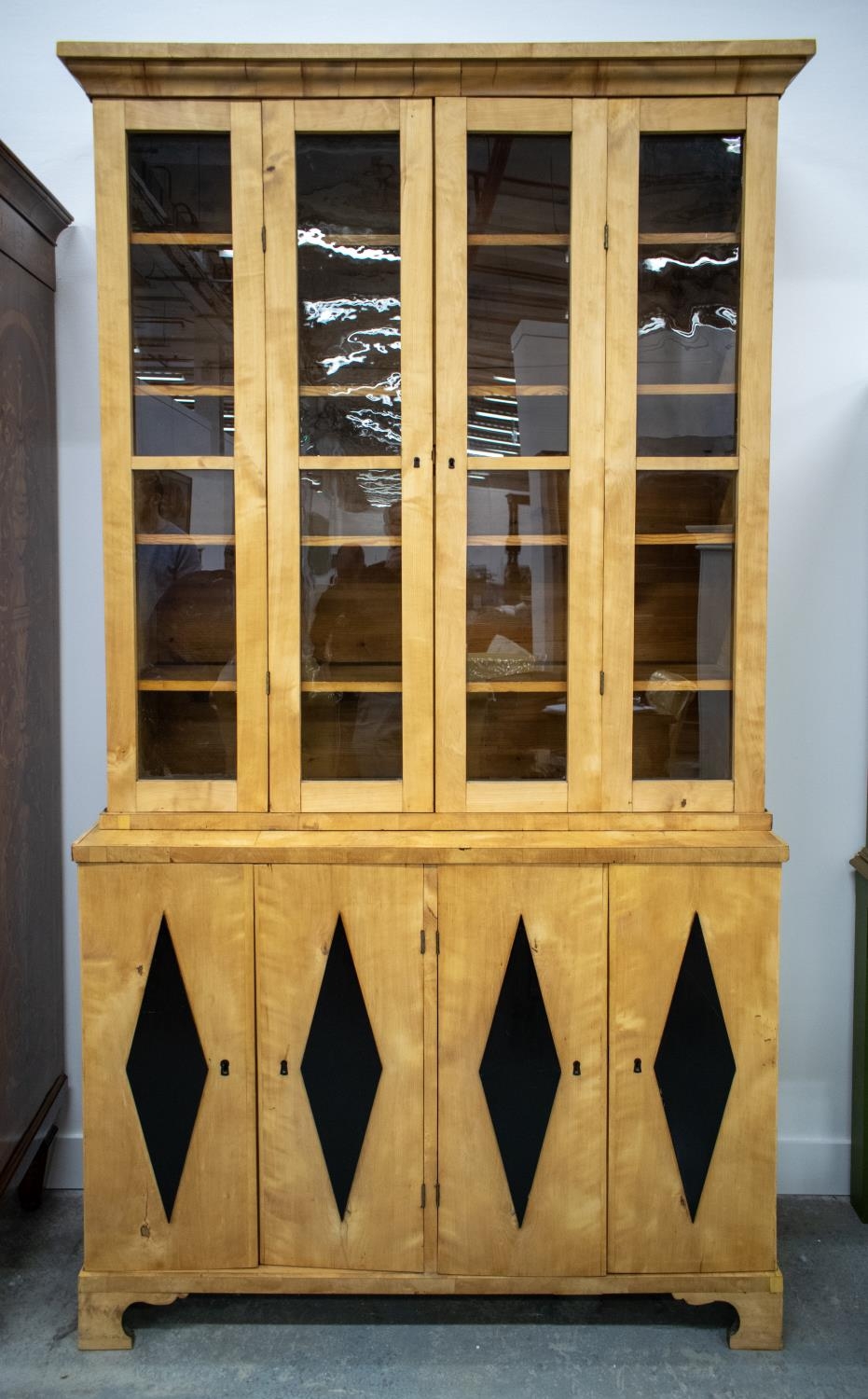 BOOKCASE, 19th century Swedish birch and ebonised with double hinged glazed doors enclosing fixed