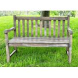 GARDEN BENCH, well weathered teak of slatted and pegged construction with shaped arms, 120cm W.