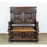 SETTLE, early 20th century Jacobean style oak with lion carved arms and hinged seat, 122cm H x