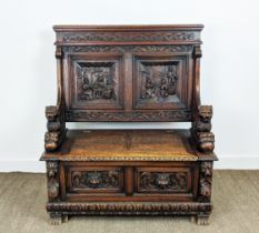 SETTLE, early 20th century Jacobean style oak with lion carved arms and hinged seat, 122cm H x