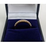 AN 18CT GOLD DIAMOND HALF ETERNITY RING, set with twelve round brilliant cut diamonds, ring size