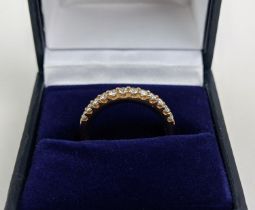 AN 18CT GOLD DIAMOND HALF ETERNITY RING, set with twelve round brilliant cut diamonds, ring size