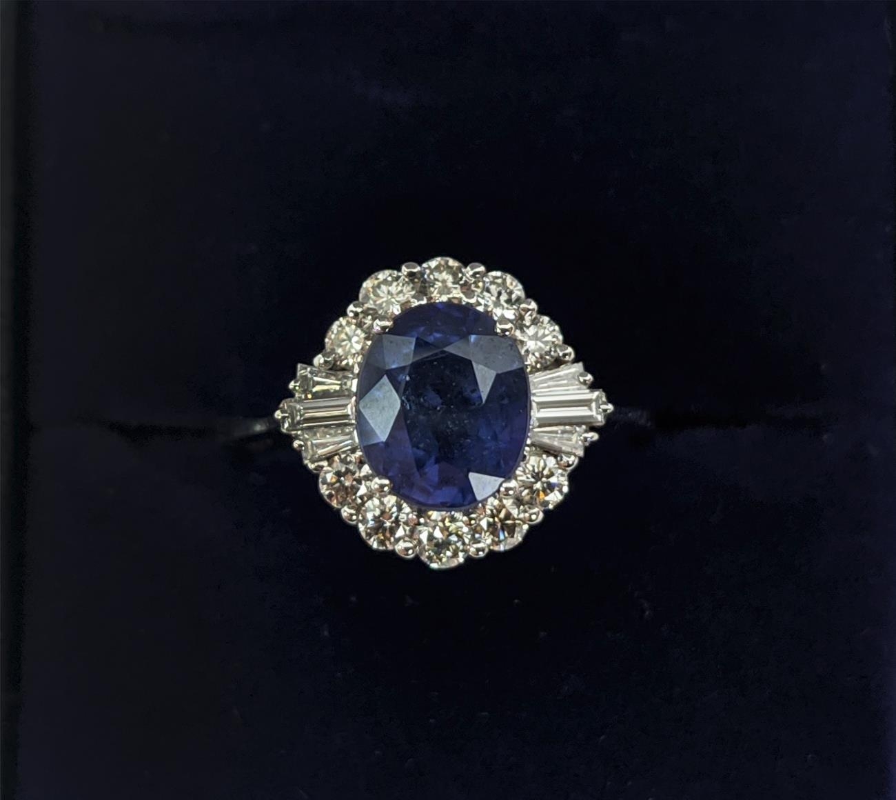 AN 18CT WHITE GOLD SAPPHIRE AND DIAMOND HALO RING, the central oval mixed cut sapphire of - Image 3 of 9