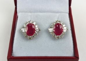 A PAIR OF 18CT WHITE GOLD RUBY AND DIAMOND STUD EARRINGS, the central mixed cut stones of