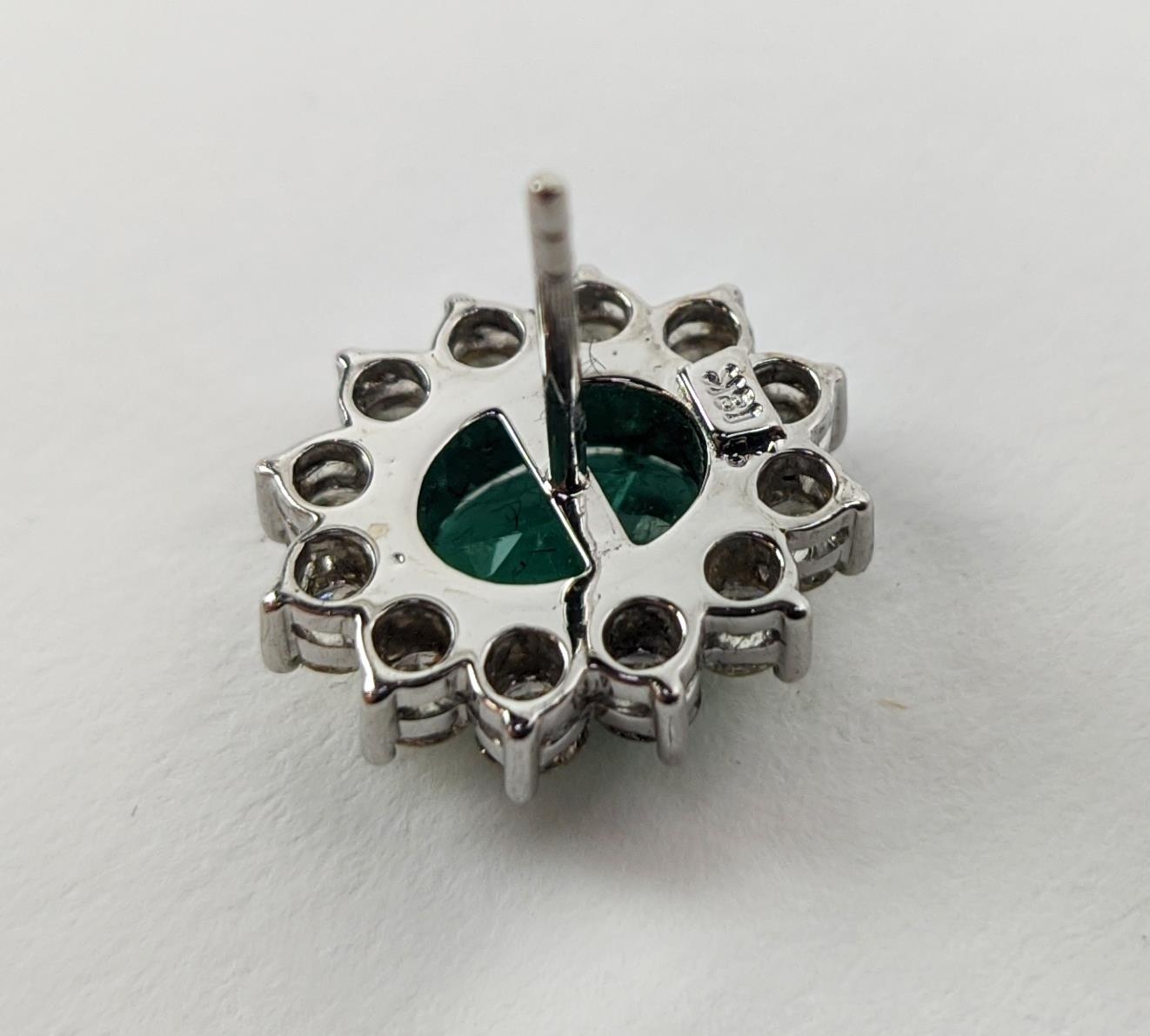 A PAIR OF 18CT WHITE GOLD EMERALD AND DIAMOND CLUSTER STUD EARRINGS, the oval mixed cut emerald - Image 6 of 8