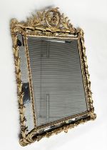 WALL MIRROR, 19th century French cream and gilt composition. cushion marginal with foliate crest,