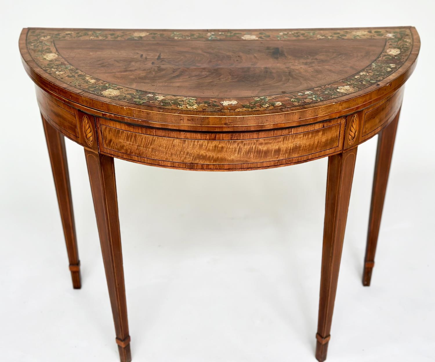 CARD TABLE, George III flame mahogany demi lune polychrome floral painted satinwood crossbanded,