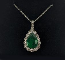 AN 18CT WHITE AND YELLOW METAL EMERALD AND DIAMOND PENDANT NECKLACE, the pendant with a pear-