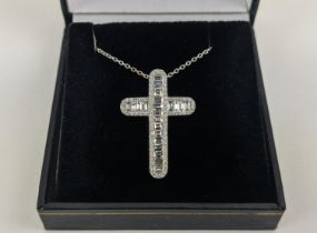 A 18CT WHITE GOLD DIAMOND SET CROSS PENDANT, set with baguette cut diamonds and a border of round