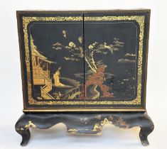 CABINET ON STAND, English Regency Chinoiserie decorated, lacquer work with hinged doors revealing