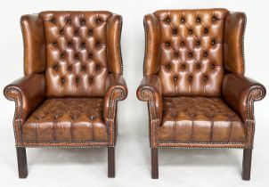 WINGBACK ARMCHAIRS, a pair, George III design natural antique tan brown brass studded leather
