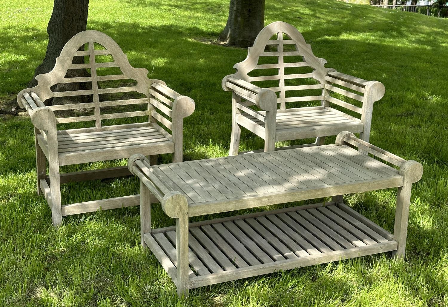 LUTYENS STYLE GARDEN ARMCHAIRS, a pair, well weathered teak, 103cm H x 90cm W, together with a