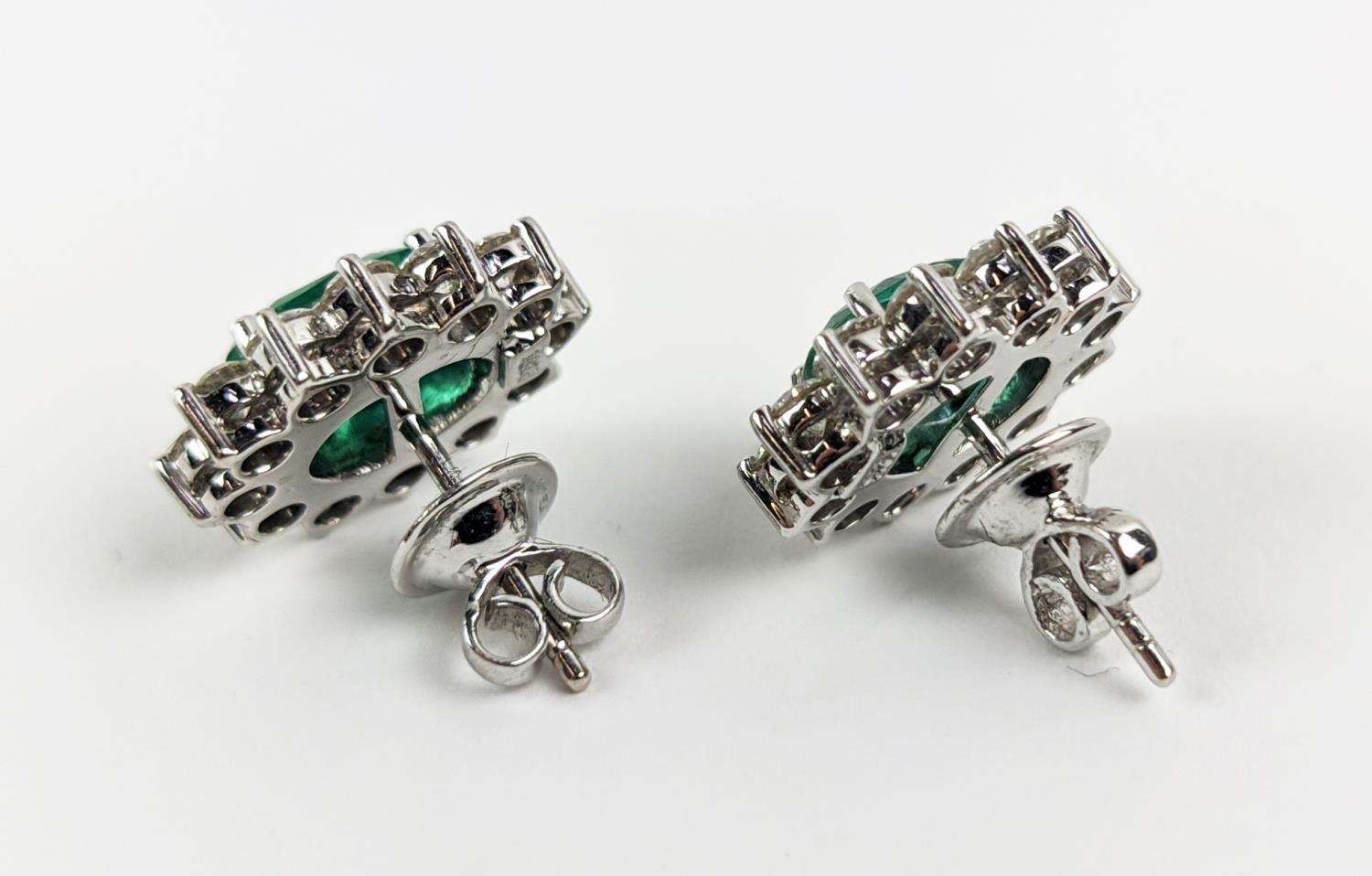 A PAIR OF 18CT WHITE GOLD EMERALD AND DIAMOND CLUSTER STUD EARRINGS, the oval mixed cut emerald - Image 5 of 8