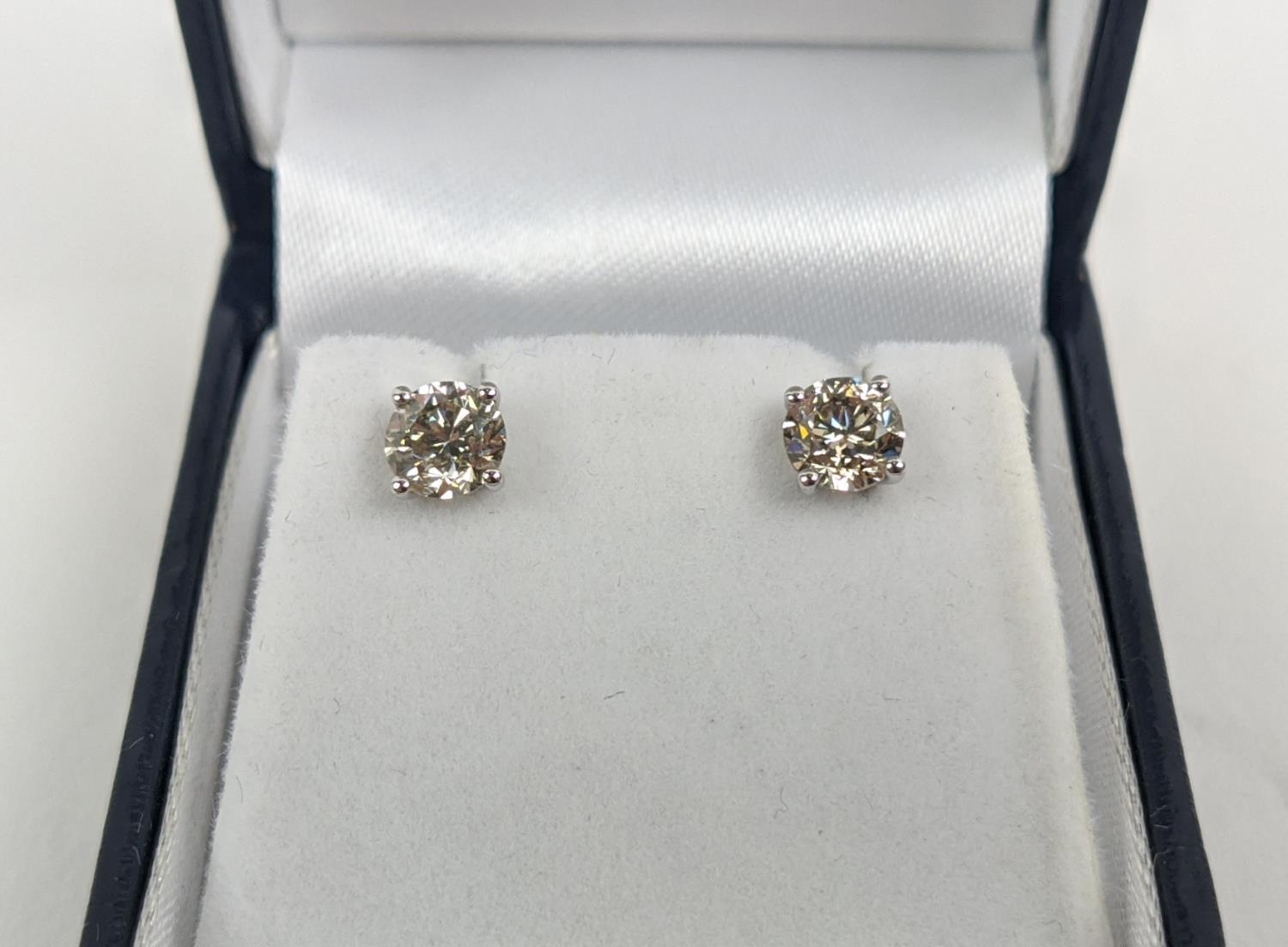 A PAIR OF 18CT WHITE GOLD DIAMOND SOLITAIRE STUD EARRINGS, each with a claw set round brilliant - Image 2 of 6