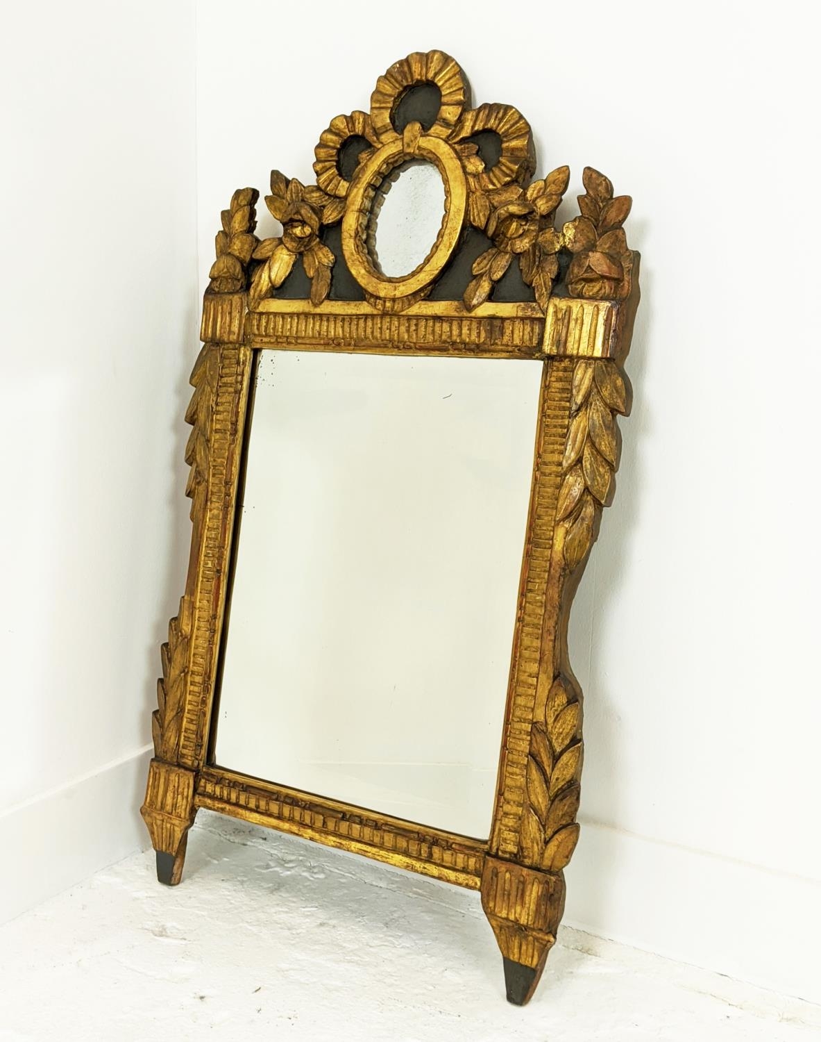 WALL MIRROR, Louis XVI giltwood and painted with bevelled plate and oval mirrored inset crest,