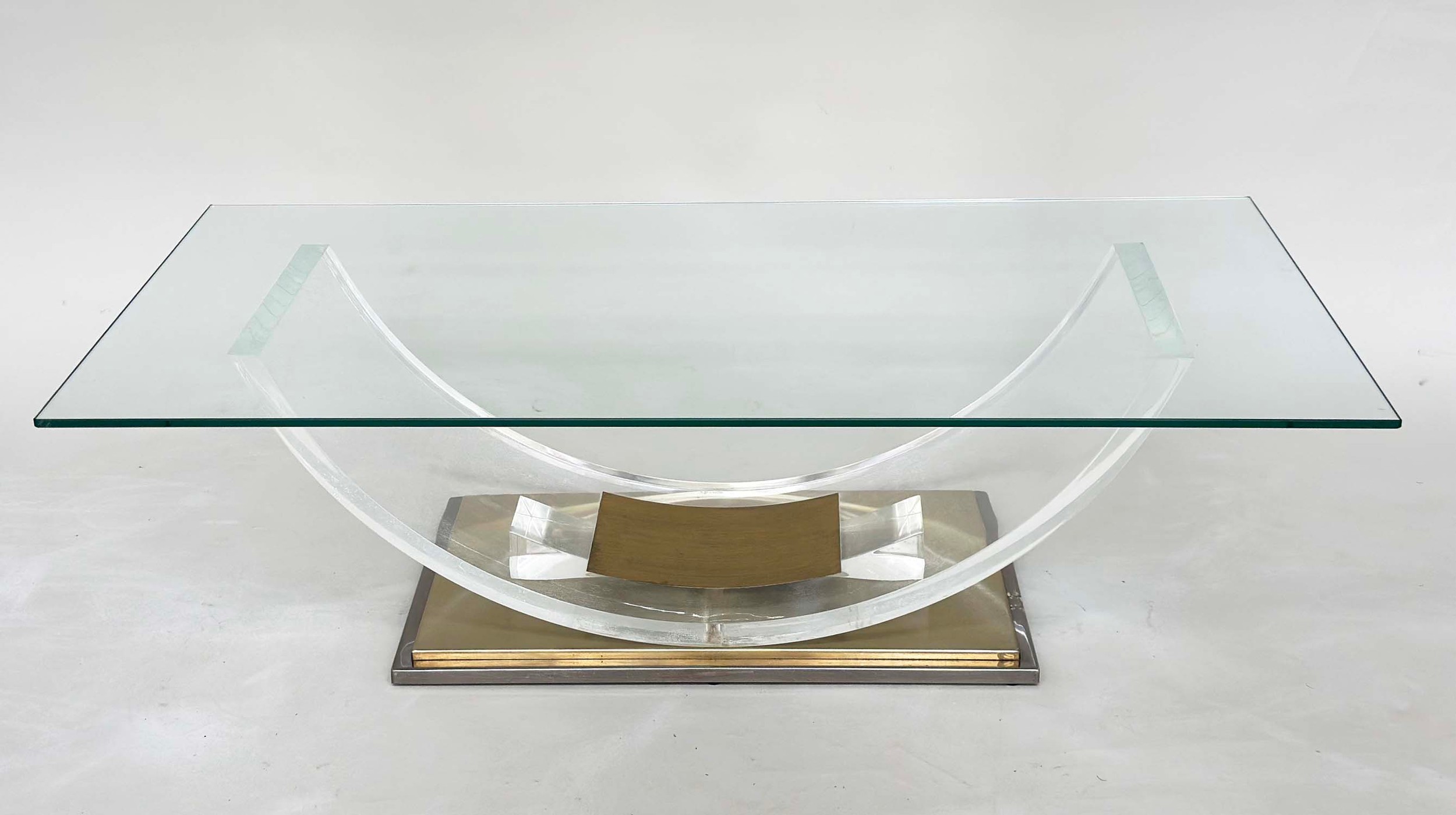 BELGO CHROME LUCITE LOW TABLE, rectangular glazed on curved lucite support and gilt metal base,