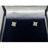 A PAIR OF 18CT WHITE DIAMOND SOLITAIRE STUD EARRINGS, each with princess cut diamonds of