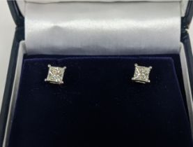 A PAIR OF 18CT WHITE DIAMOND SOLITAIRE STUD EARRINGS, each with princess cut diamonds of