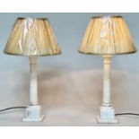 TABLE LAMPS, a pair, white marble Corinthian capped fluted columns on square plinths, (with shades),