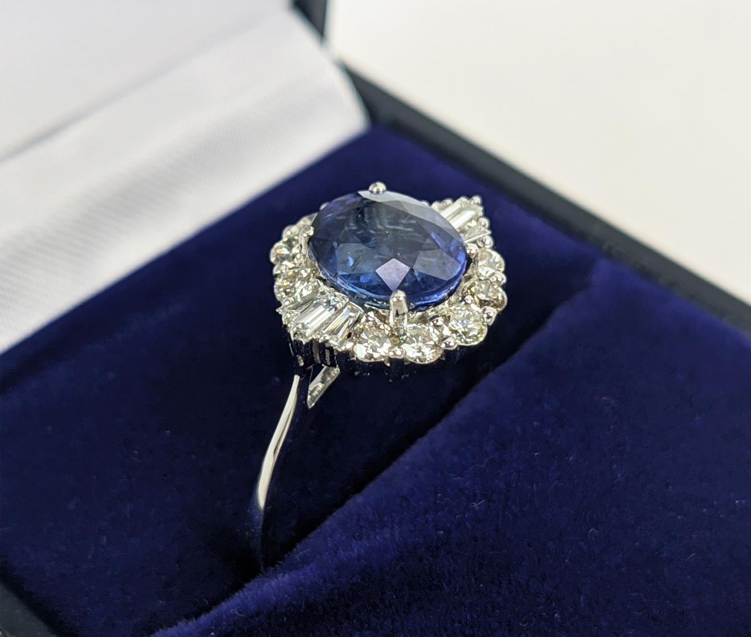 AN 18CT WHITE GOLD SAPPHIRE AND DIAMOND HALO RING, the central oval mixed cut sapphire of - Image 4 of 9