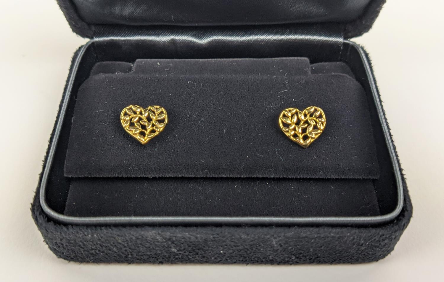 A PAIR OF TIFFANY 18CT GOLD STUD EARRINGS, in the form of hearts with pierced foliage design,