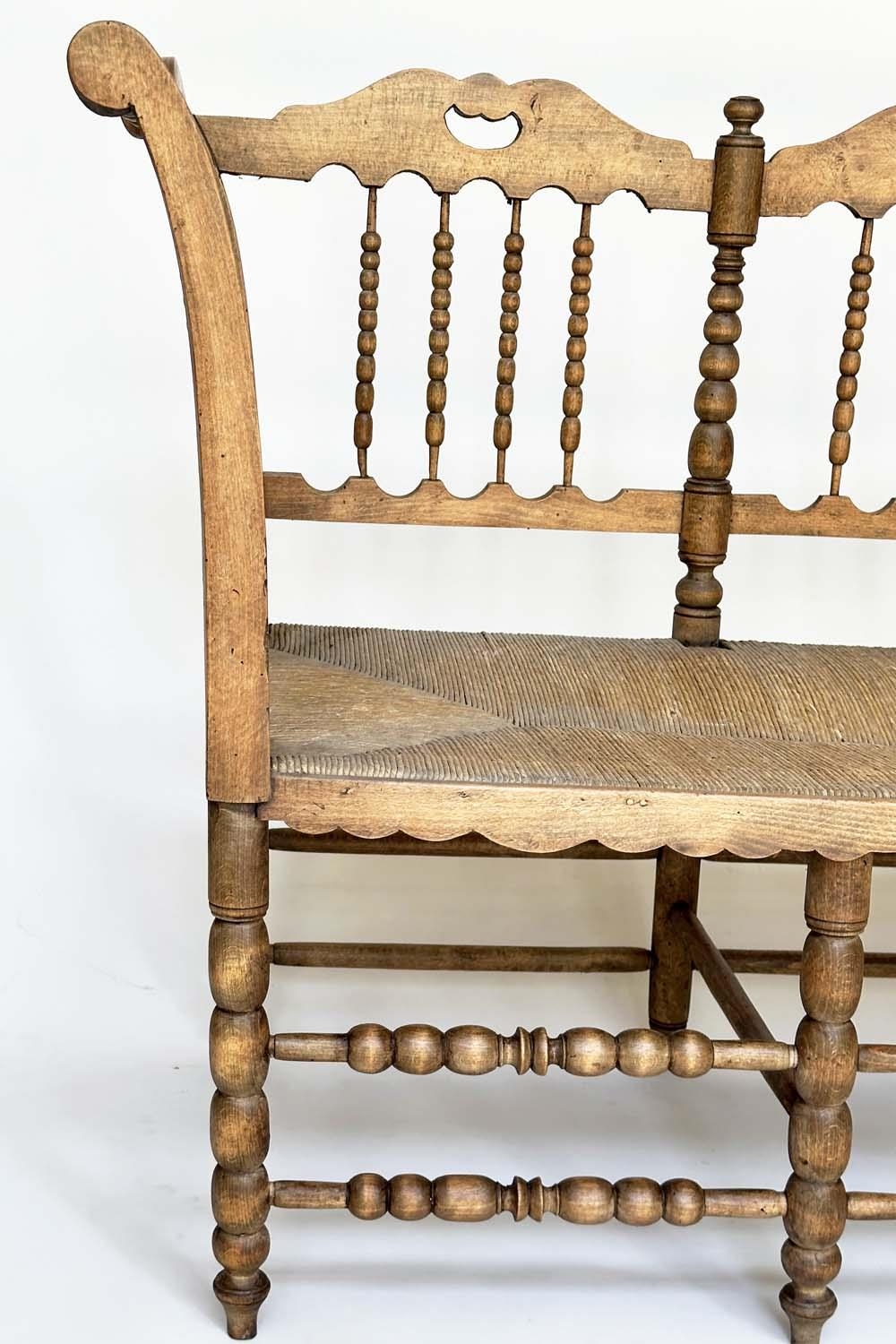 HALL SEAT, 19th century English, William Morris style fruitwood with bobbin turned frame and rush - Image 4 of 11