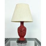 CINNABAR STYLE LACQUER LAMP, early 20th century, carved with a fine claw dragon on a rosewood carved