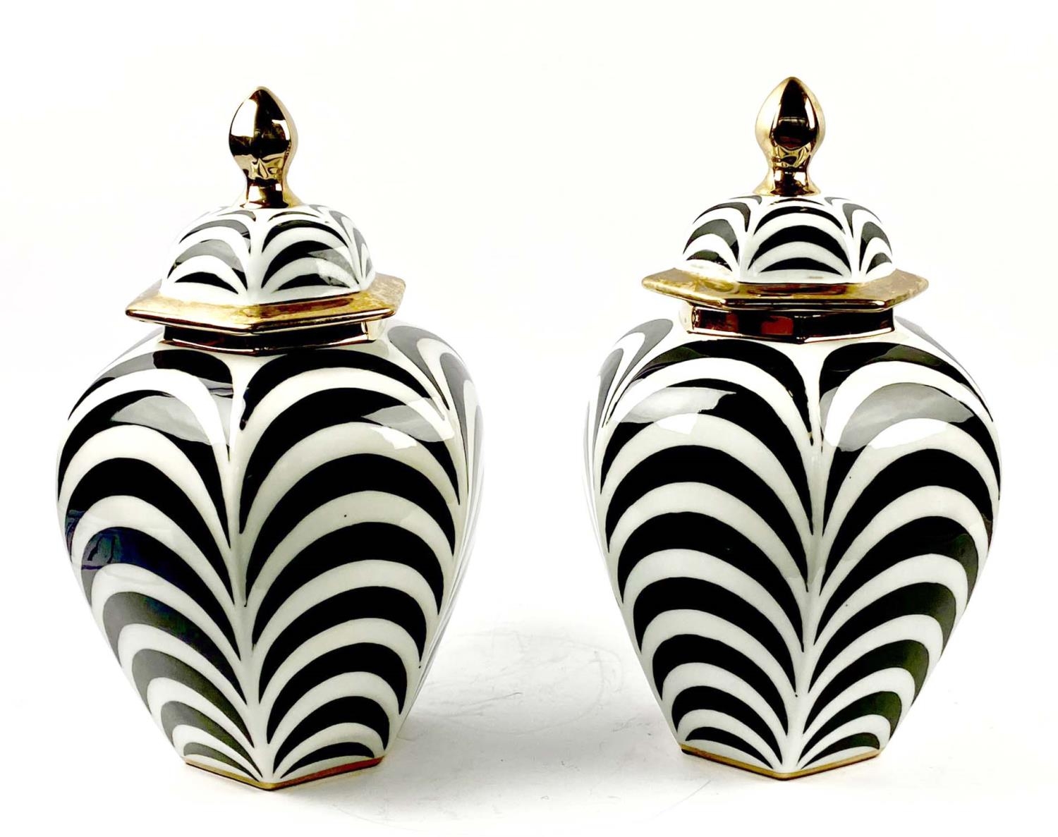 GINGER JARS, a pair, glazed ceramic with black and white decoration, gilt accents, 40cm high, 26cm