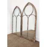 GARDEN MIRRORS, a pair, with arched metal frames, 123cm H x 56cm W. (2)