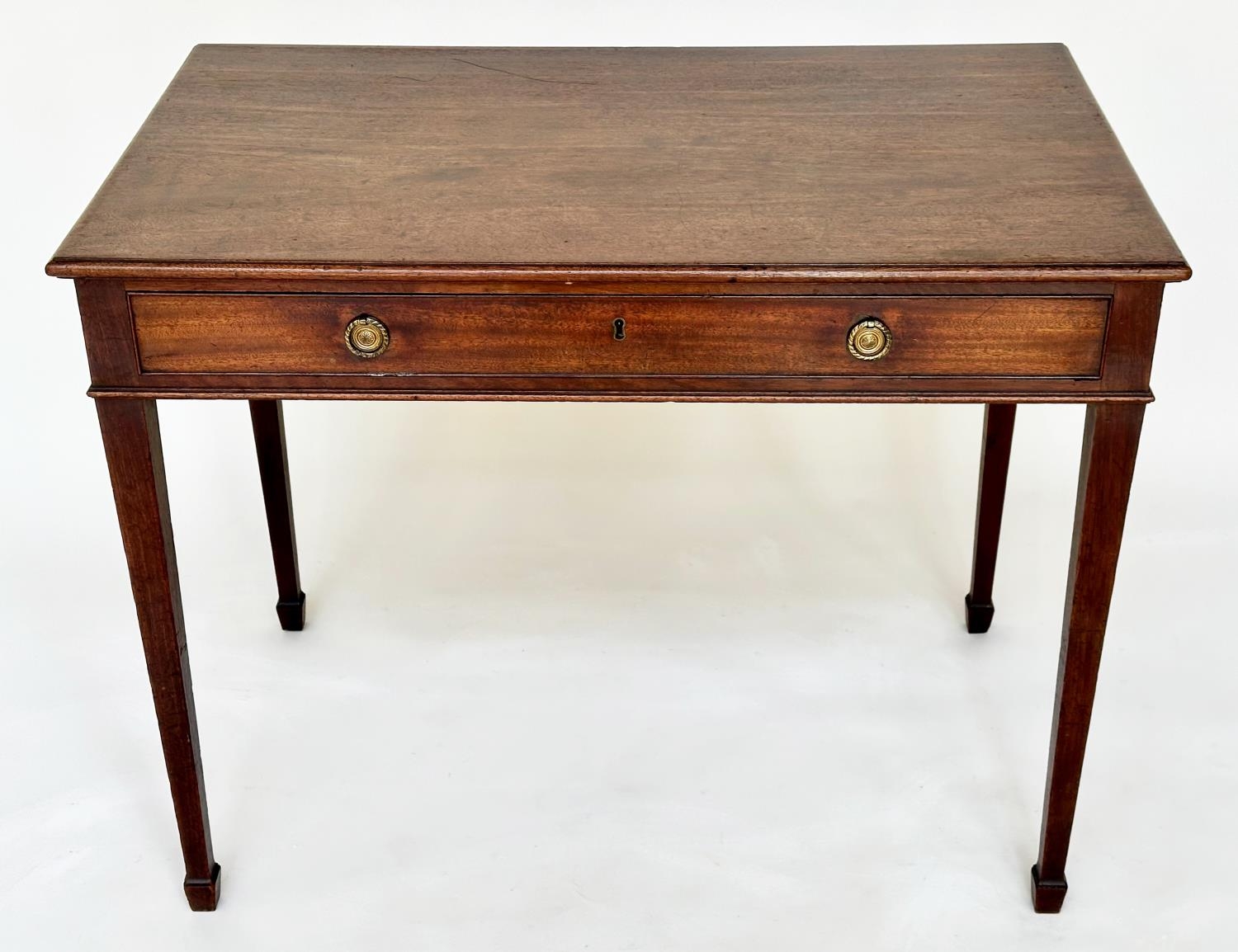 WRITING TABLE, George III period mahogany with full width frieze drawer and square tapering
